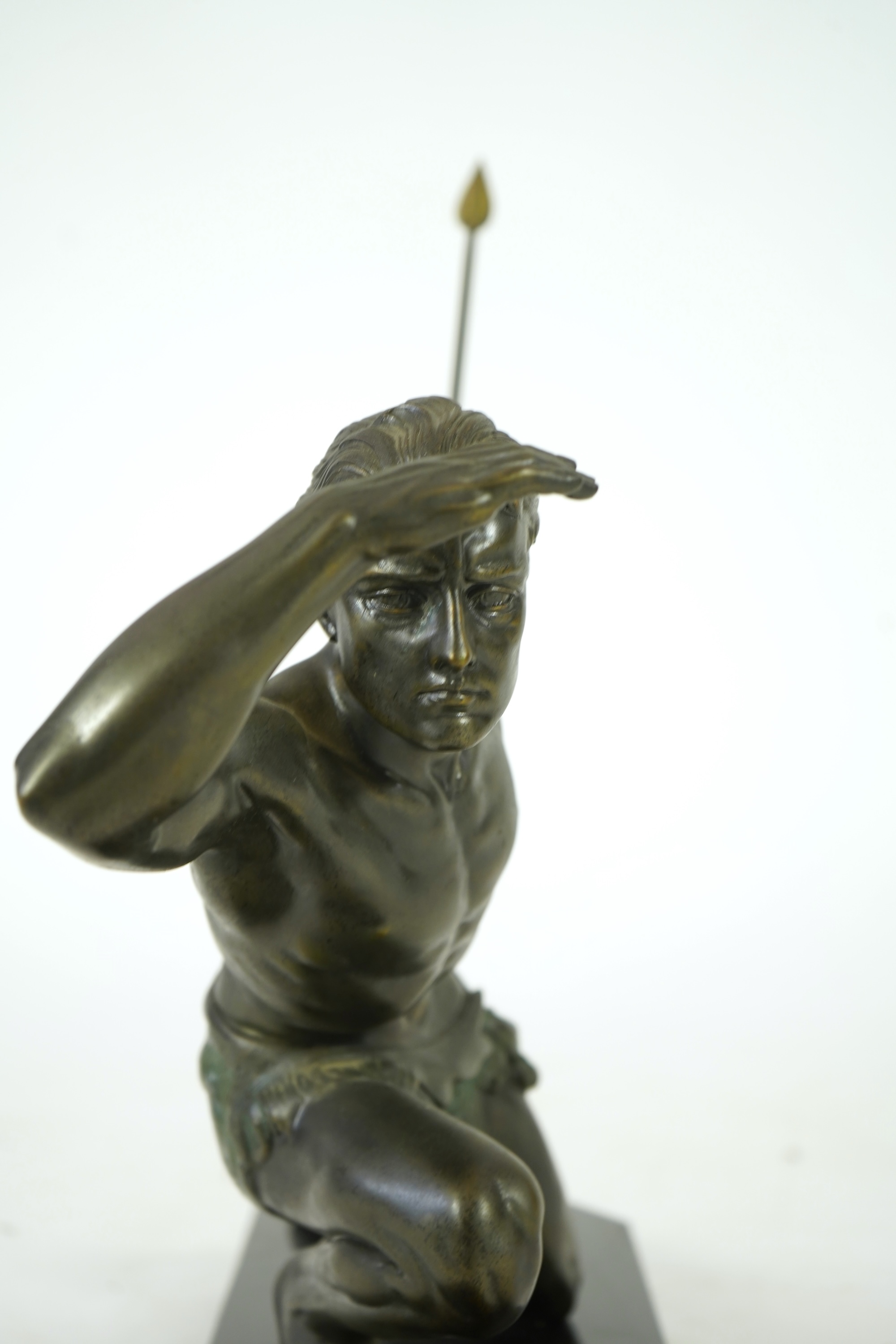 Manner of Jean de Roncourt (1869-1937) An Art Deco patinated bronze sculpture of a male hunter with spear on black marble stand